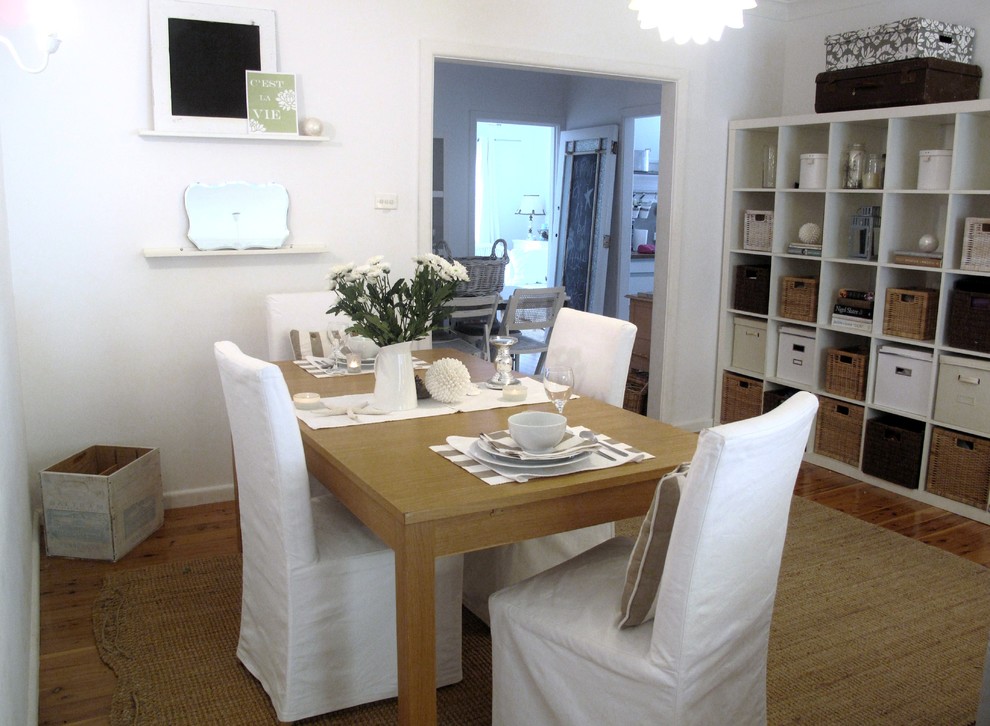 Cottage chic dark wood floor dining room photo in Sydney with white walls