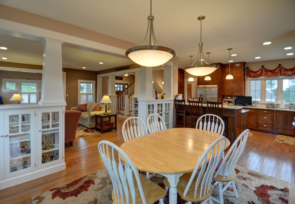 Photo of a medium sized classic kitchen/dining room in Columbus with beige walls and medium hardwood flooring.
