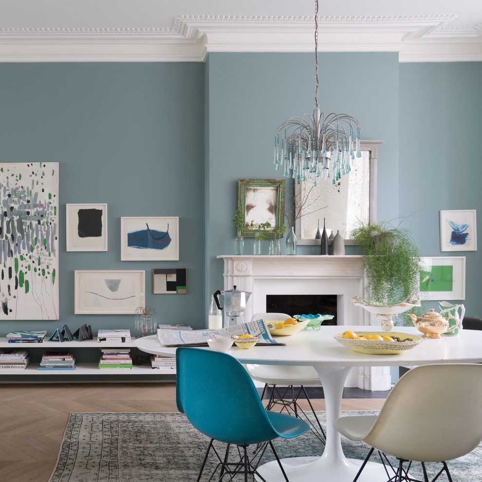 Modelo de comedor clásico renovado con paredes azules, suelo de madera en tonos medios y suelo marrón