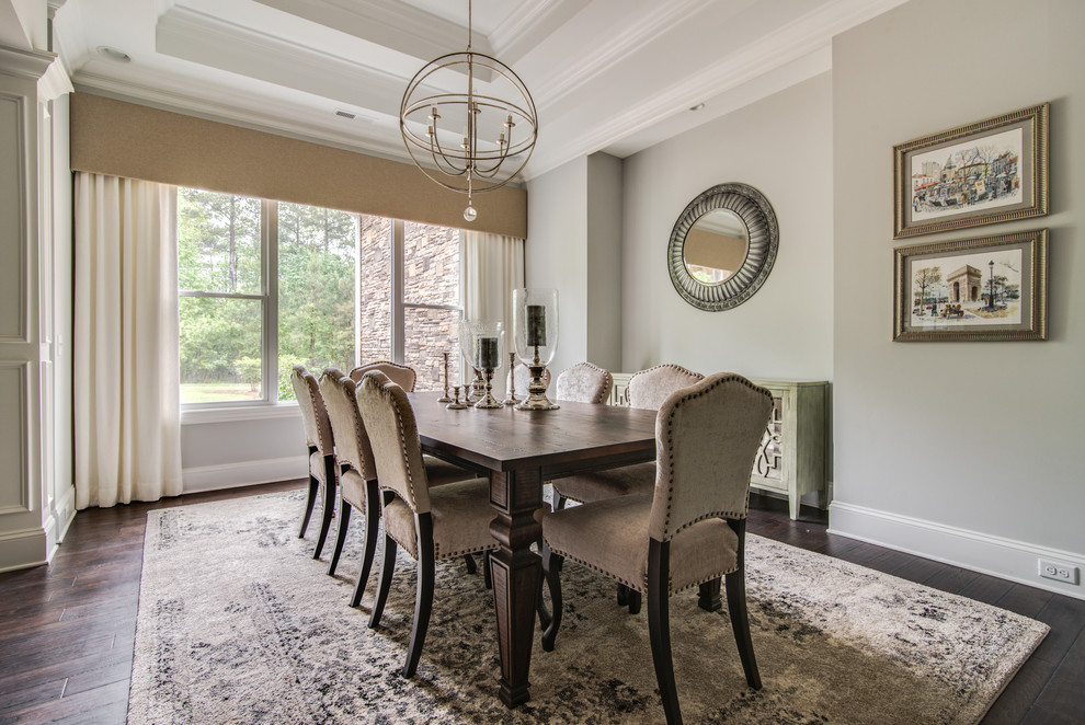 Photo of a medium sized traditional enclosed dining room in Charlotte with dark hardwood flooring, grey walls, no fireplace and brown floors.