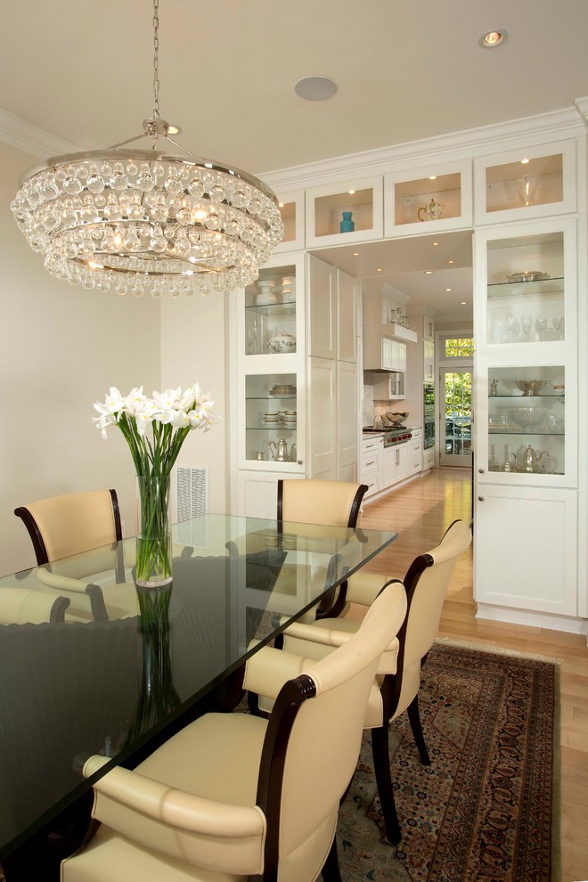 Example of a large classic light wood floor and beige floor enclosed dining room design in DC Metro with white walls
