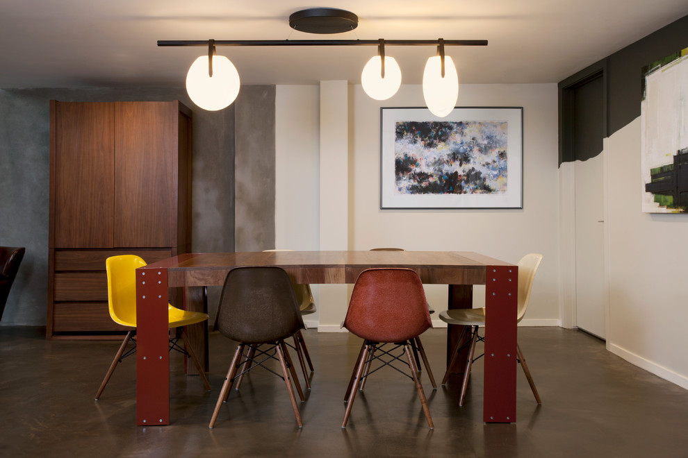 Photo of an industrial dining room in San Francisco with multi-coloured walls and brown floors.