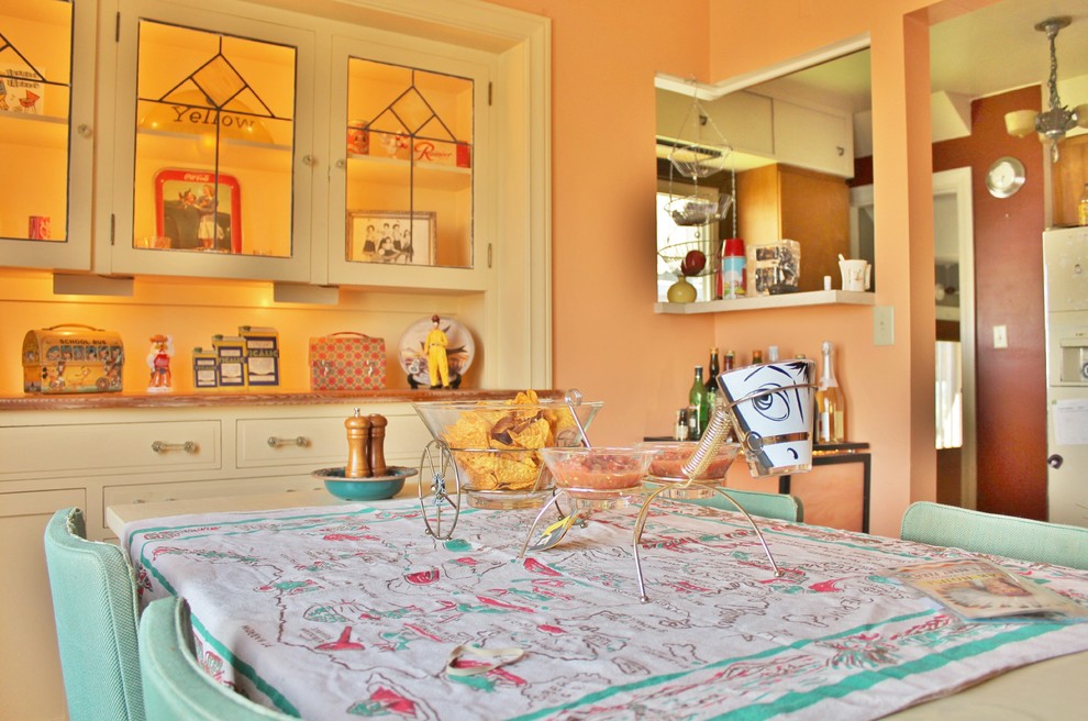 Eclectic enclosed dining room photo in Seattle with orange walls