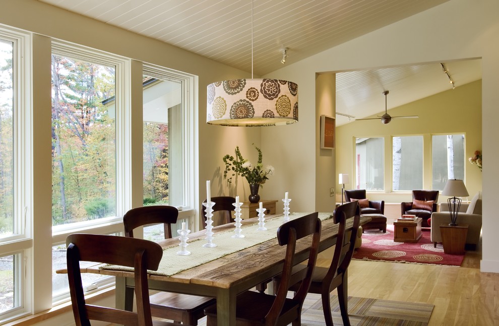 Example of a trendy medium tone wood floor dining room design in Burlington with beige walls