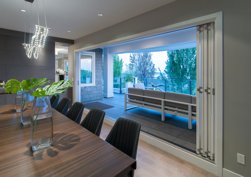 Design ideas for an expansive contemporary open plan dining room in Vancouver with grey walls and medium hardwood flooring.
