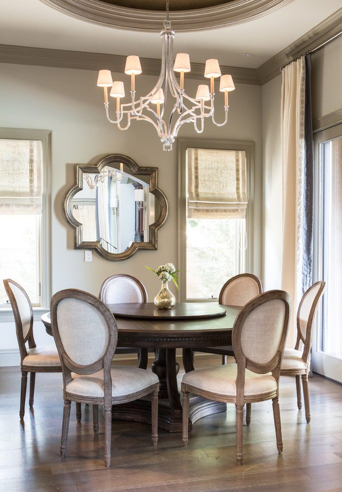 This is an example of a traditional dining room in Los Angeles with beige walls and medium hardwood flooring.