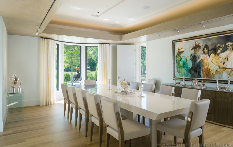 Design ideas for a large contemporary enclosed dining room in Boston with beige walls, medium hardwood flooring and no fireplace.