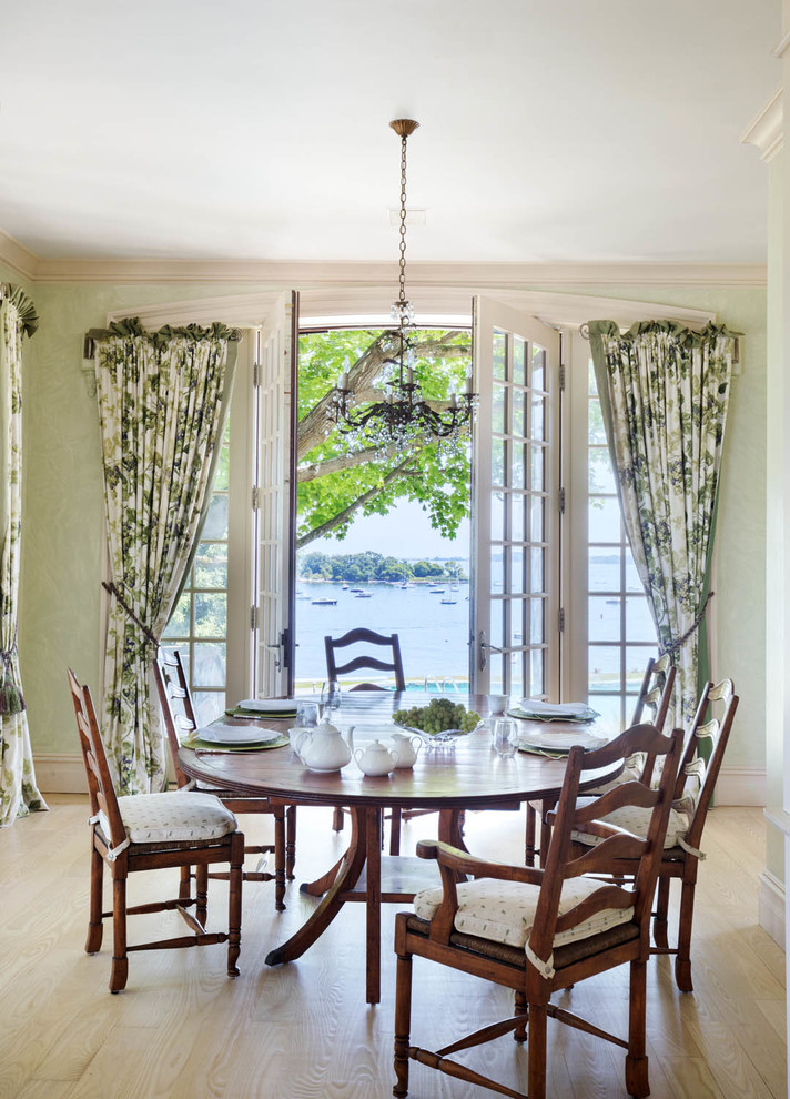Huge elegant light wood floor and beige floor dining room photo in New York with green walls