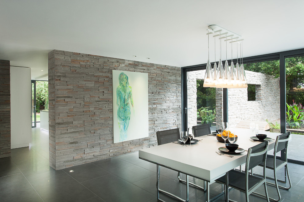 Example of a minimalist ceramic tile dining room design in Hampshire