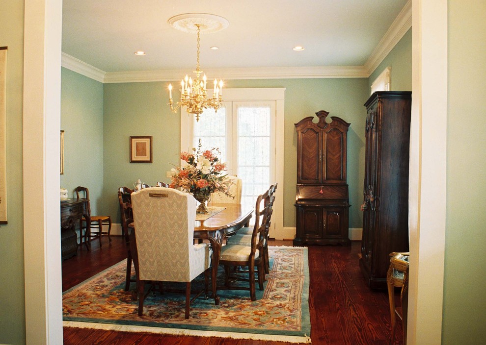 Photo of a classic dining room in Atlanta with green walls and dark hardwood flooring.