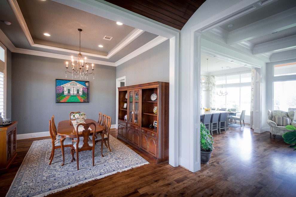 This is an example of a medium sized farmhouse enclosed dining room in Houston with grey walls, medium hardwood flooring and brown floors.