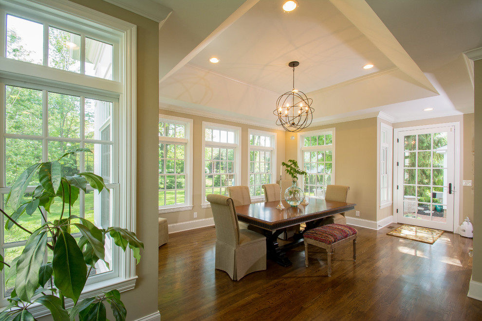 Example of a classic medium tone wood floor kitchen/dining room combo design in Columbus with beige walls