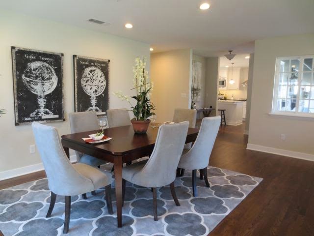 Medium sized contemporary open plan dining room in Sacramento with beige walls, dark hardwood flooring and brown floors.