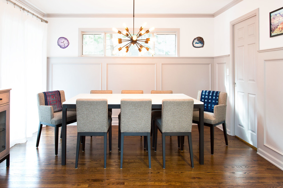 This is an example of a small contemporary enclosed dining room in San Francisco with white walls, medium hardwood flooring, no fireplace and brown floors.