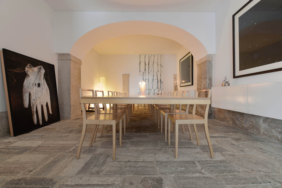 Inspiration for a large mediterranean dining room with beige walls and limestone flooring.