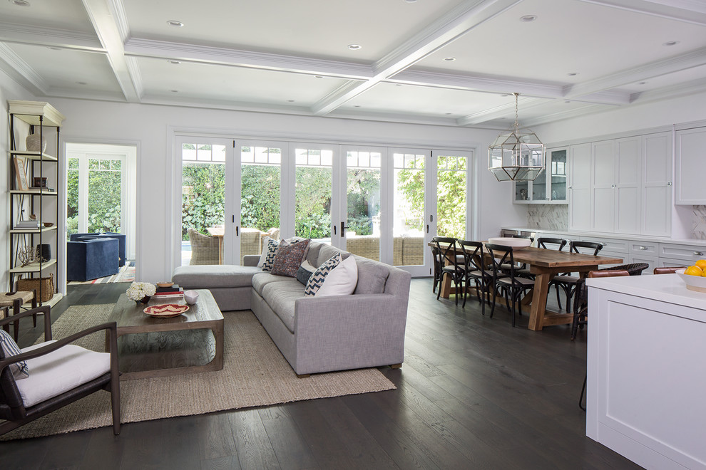 Great room - large traditional dark wood floor great room idea in Los Angeles with gray walls and no fireplace