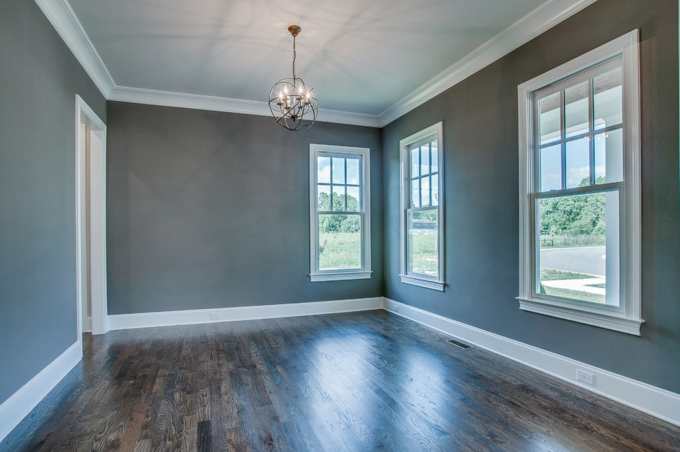 Large traditional enclosed dining room in Nashville with green walls, dark hardwood flooring and no fireplace.