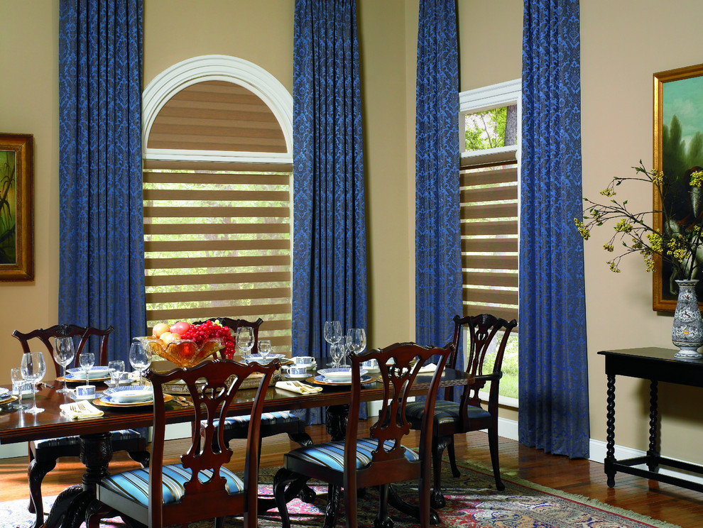 Inspiration for a mid-sized contemporary medium tone wood floor and brown floor enclosed dining room remodel in Miami with beige walls and no fireplace