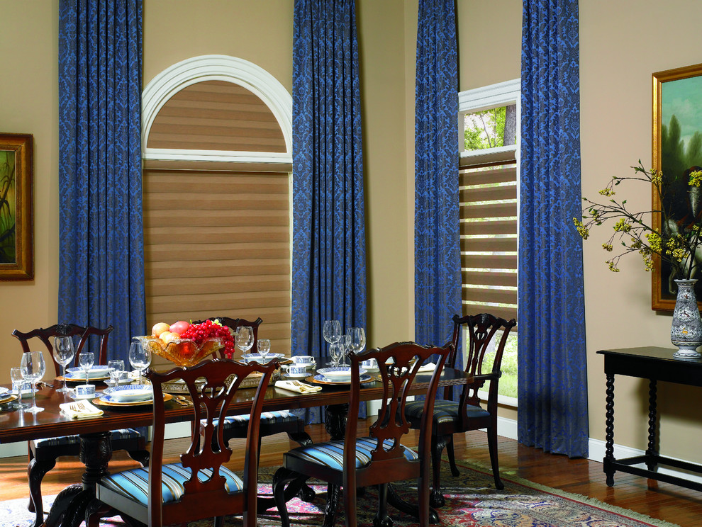Mid-sized trendy medium tone wood floor and brown floor enclosed dining room photo in Miami with beige walls and no fireplace