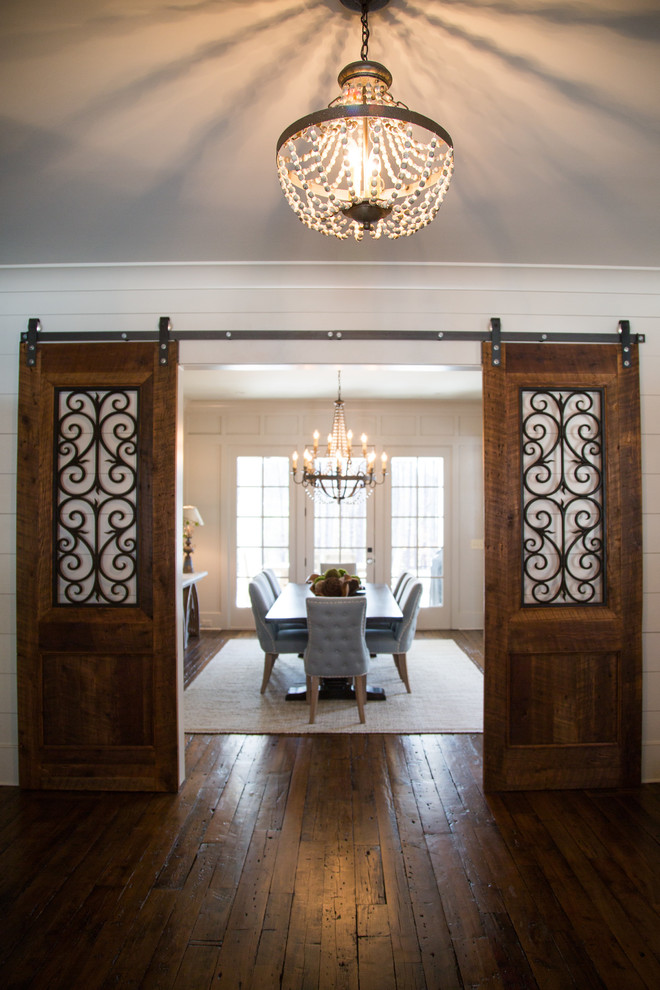 Inspiration for a mid-sized transitional medium tone wood floor enclosed dining room remodel in Atlanta with white walls