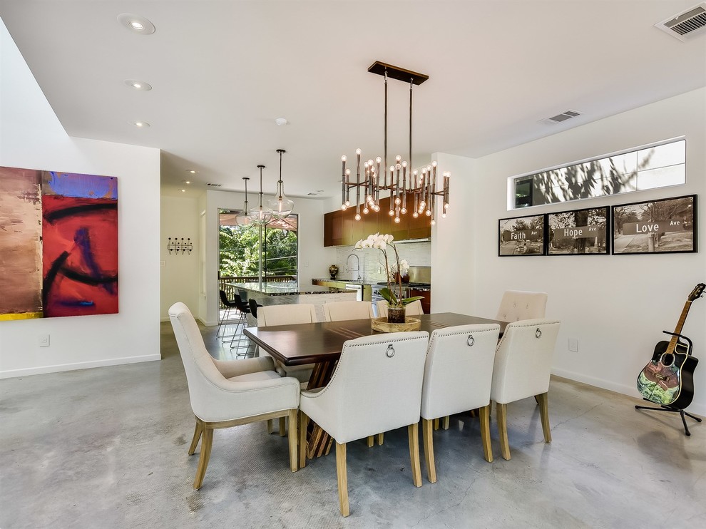 Mid-sized trendy concrete floor dining room photo in Austin with white walls and no fireplace