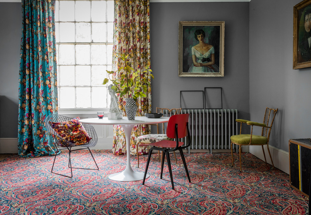 Inspiration for a bohemian dining room in Hampshire with grey walls and carpet.