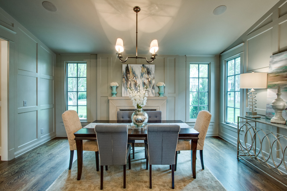 Inspiration for a medium sized classic enclosed dining room in Nashville with white walls, dark hardwood flooring, a standard fireplace and a concrete fireplace surround.
