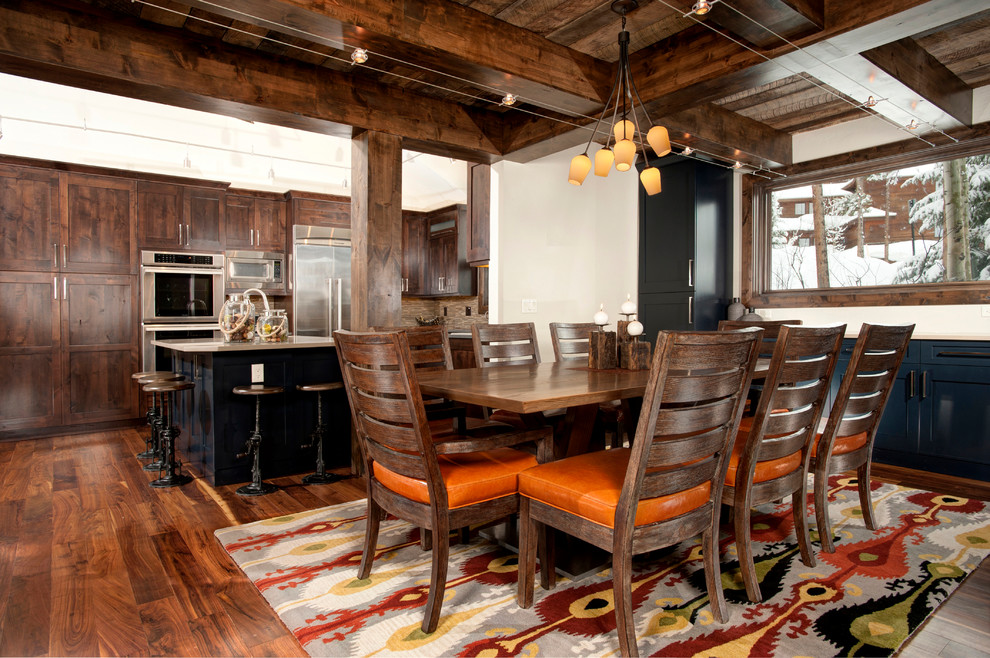 Photo of a rustic kitchen/dining room in Denver with white walls and dark hardwood flooring.