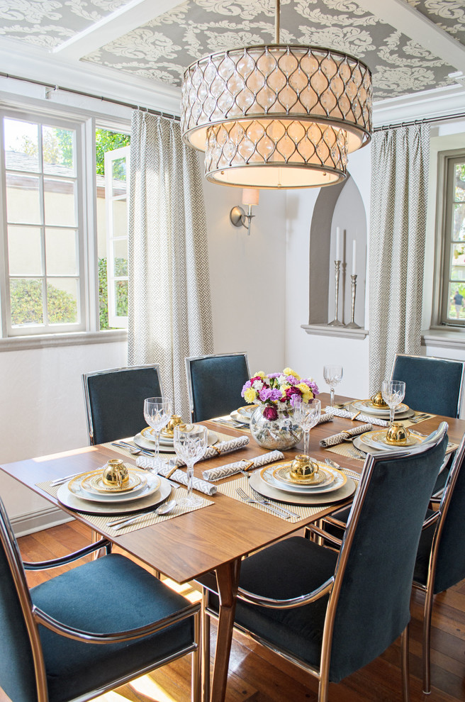 Photo of a traditional dining room in Los Angeles with white walls and medium hardwood flooring.