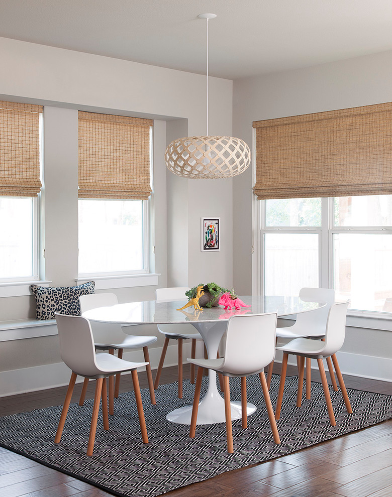 Traditional dining room in Austin with beige walls, medium hardwood flooring and orange floors.