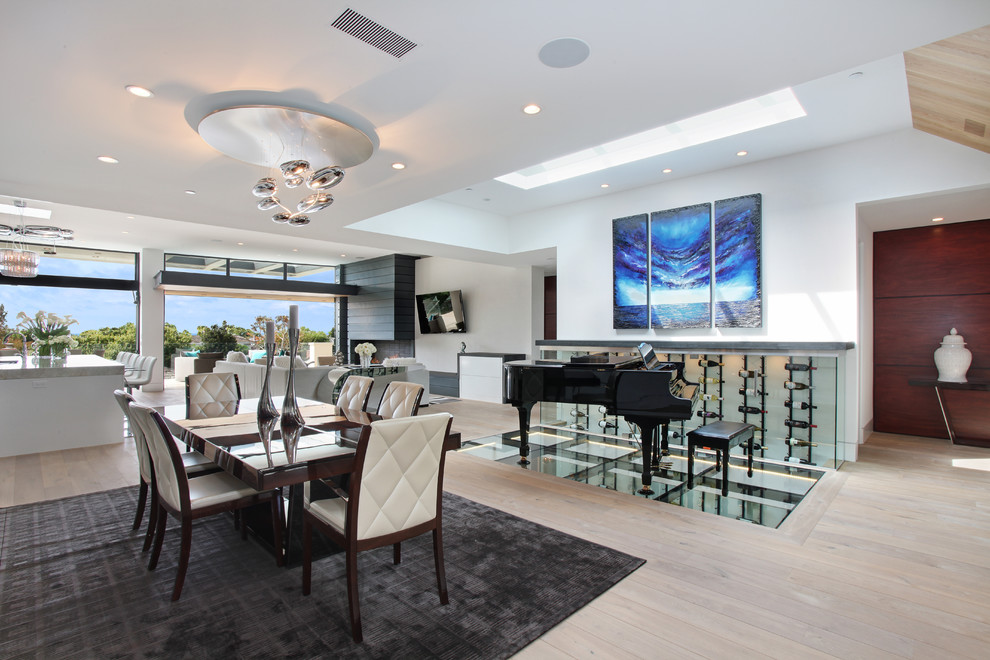 Modern dining room in Orange County with feature lighting.