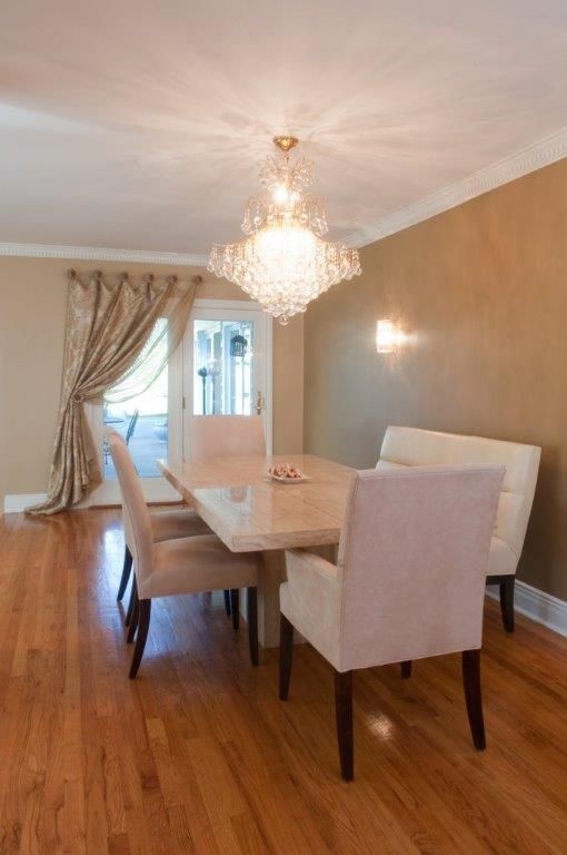 Mid-sized elegant medium tone wood floor enclosed dining room photo in New York with brown walls and a stone fireplace