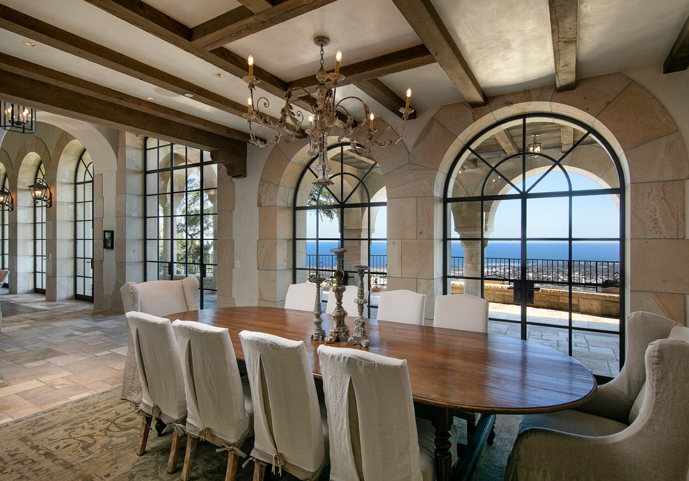 This is an example of a large mediterranean kitchen/dining room in Santa Barbara with beige walls, limestone flooring, no fireplace and beige floors.