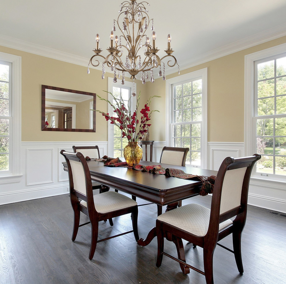 Large trendy medium tone wood floor enclosed dining room photo in New York with beige walls