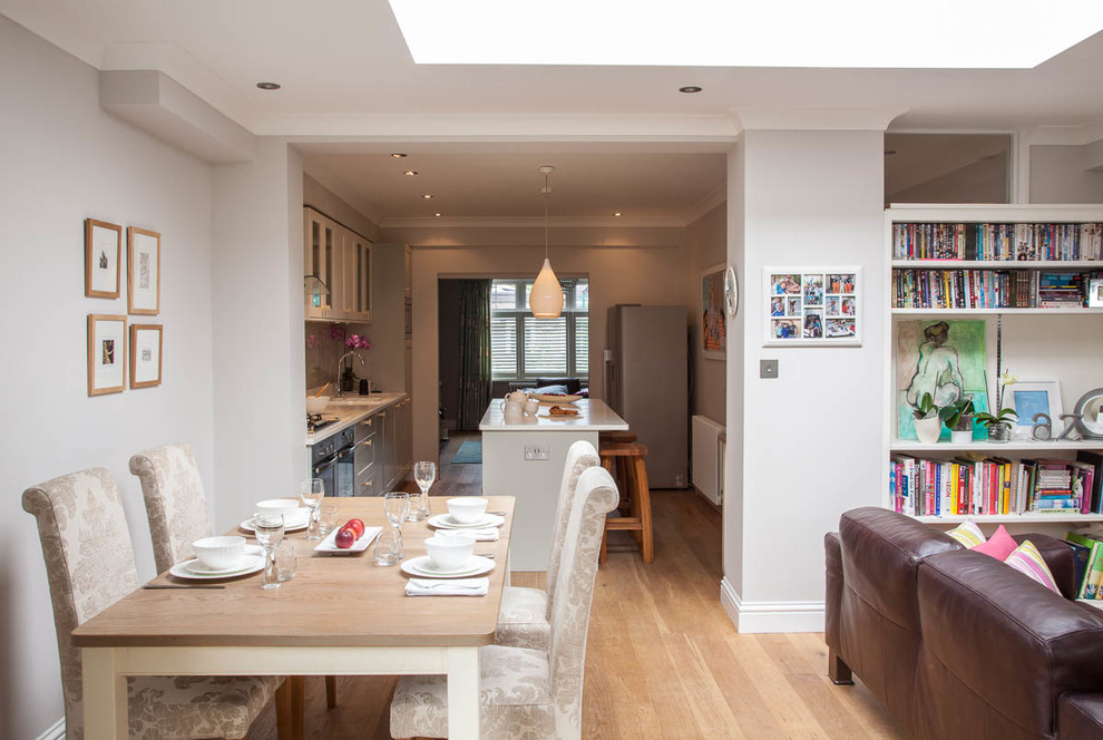 Design ideas for a medium sized contemporary open plan dining room in Surrey with medium hardwood flooring.