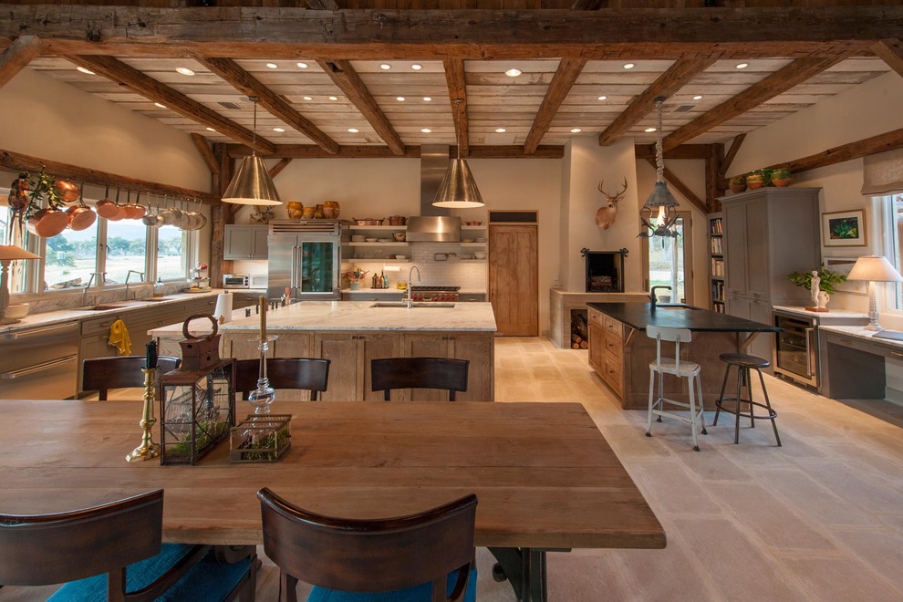 Idee per una grande sala da pranzo aperta verso la cucina country con pareti beige e pavimento in pietra calcarea