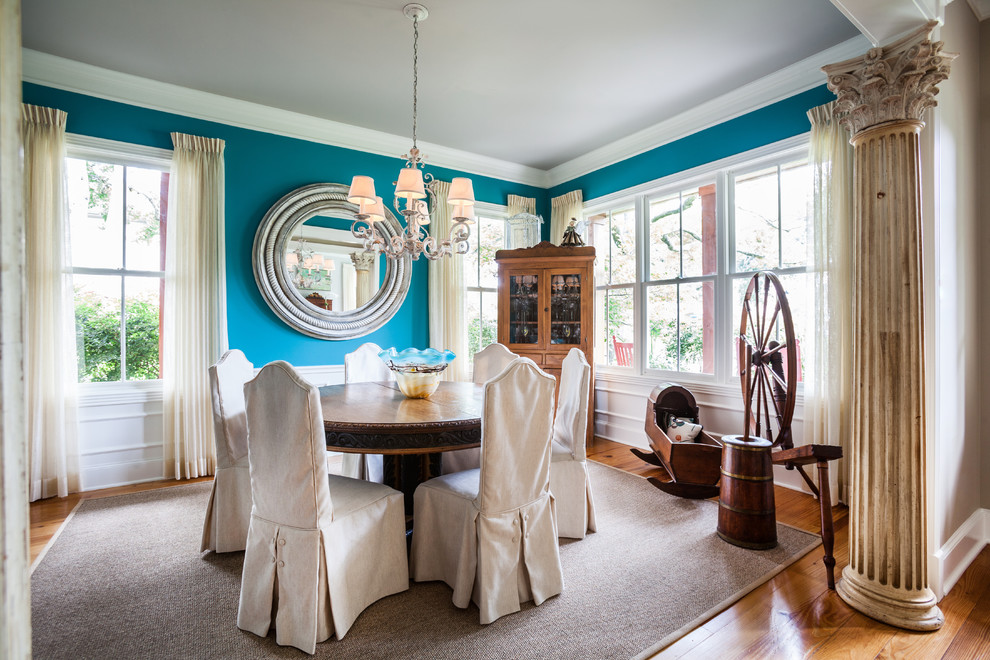 Inspiration for a large timeless medium tone wood floor enclosed dining room remodel in Houston with blue walls and no fireplace
