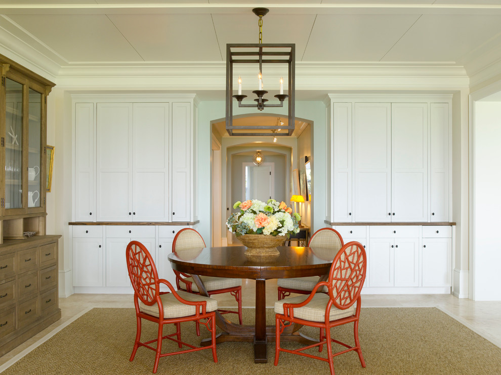 This is an example of a beach style dining room in Miami with white walls.