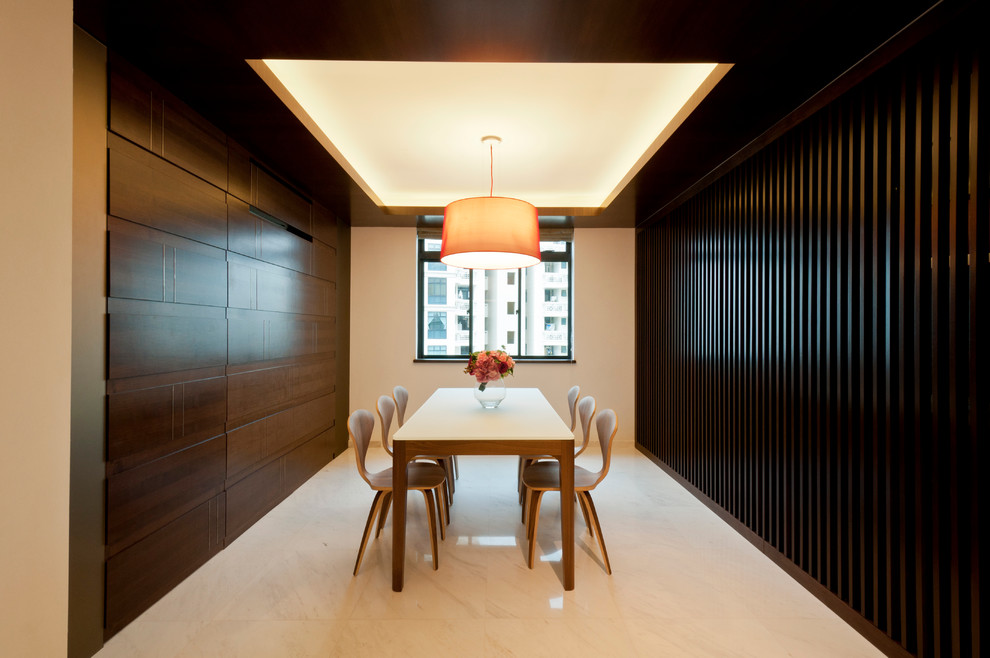 Contemporary dining room in Singapore with beige walls.