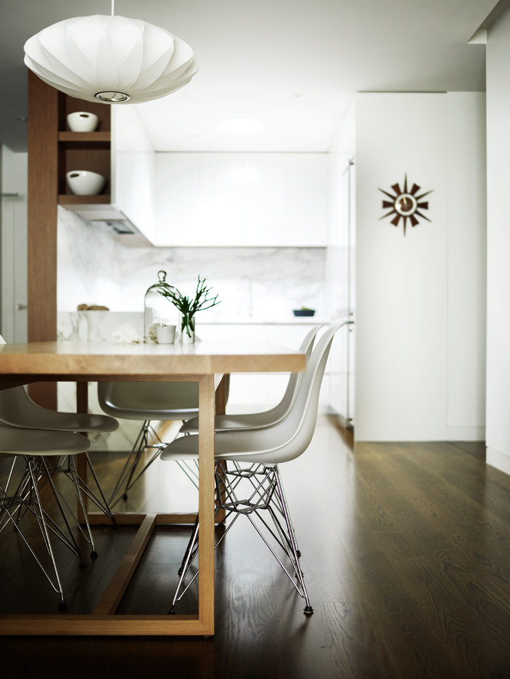 Immagine di una piccola sala da pranzo aperta verso il soggiorno design con pareti bianche e parquet scuro