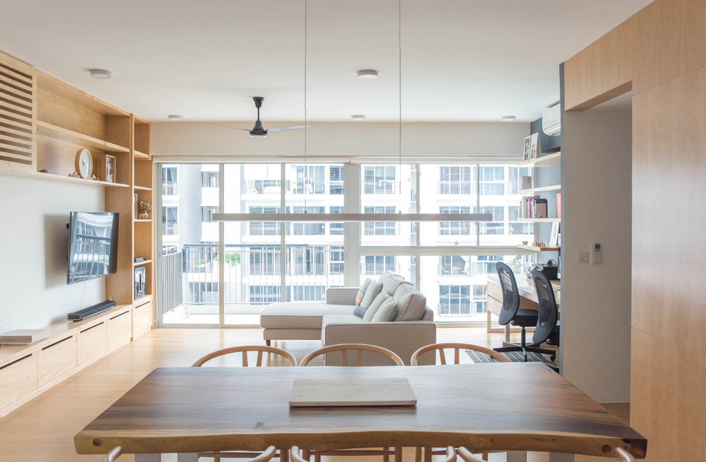 Mid-sized minimalist medium tone wood floor kitchen/dining room combo photo in Singapore with white walls