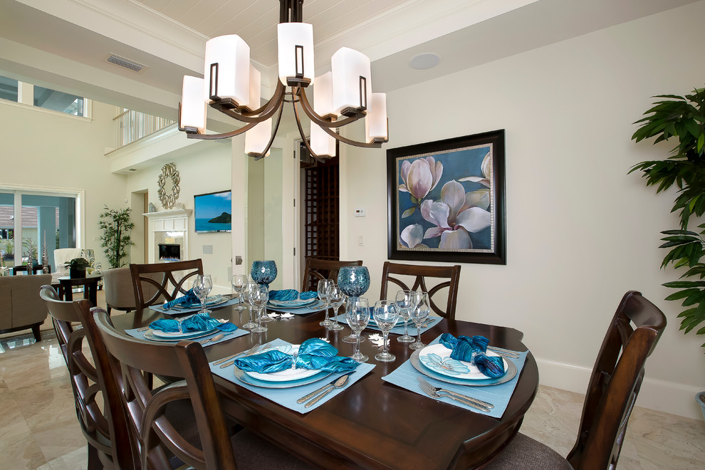 This is an example of a medium sized world-inspired open plan dining room in Miami with white walls and porcelain flooring.