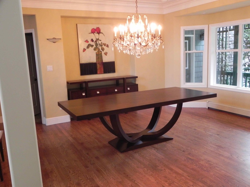 This is an example of a medium sized classic enclosed dining room in Vancouver with beige walls and medium hardwood flooring.