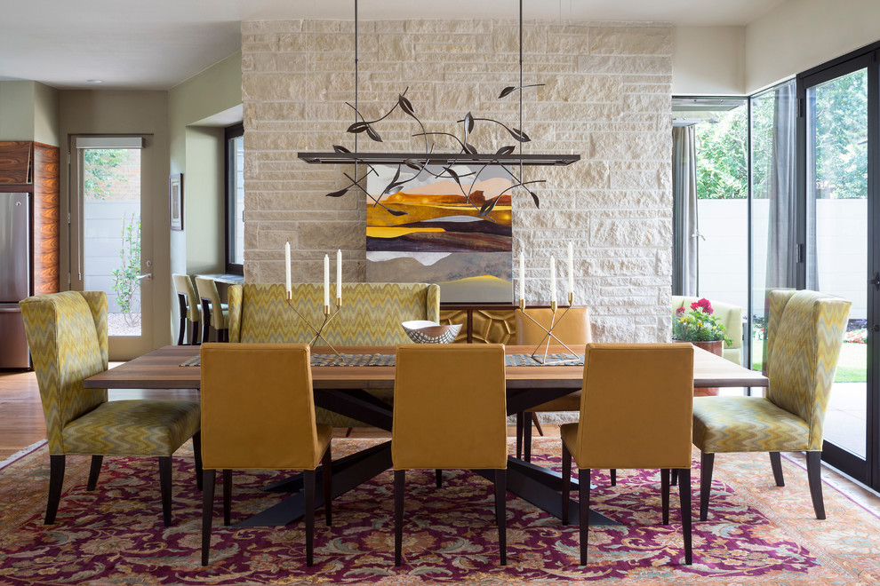 Example of a trendy dining room design in Denver with white walls