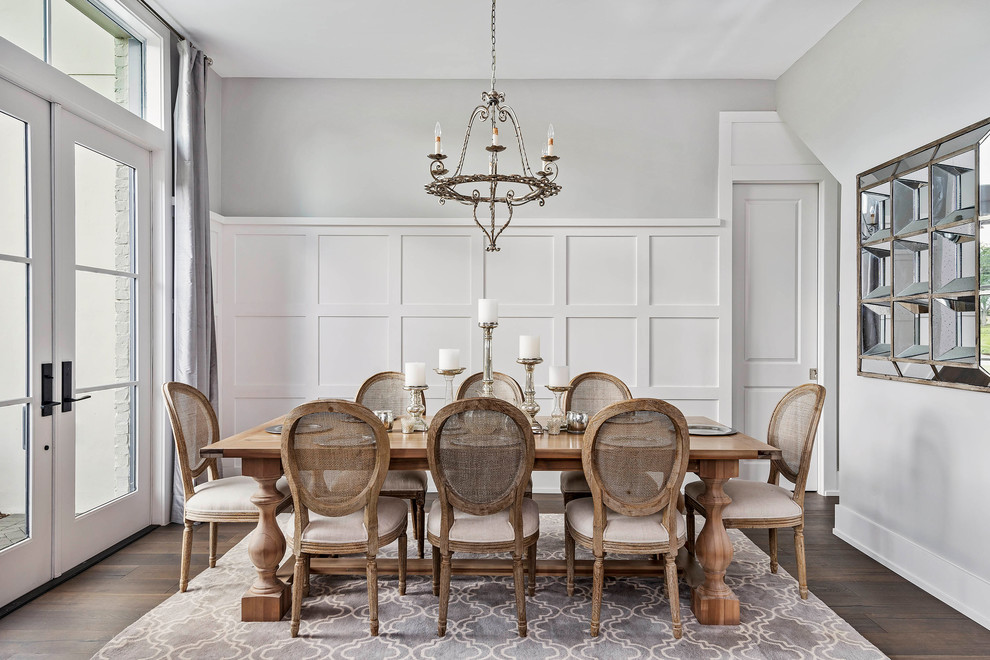 Enclosed dining room - large transitional dark wood floor and brown floor enclosed dining room idea in Orlando with gray walls