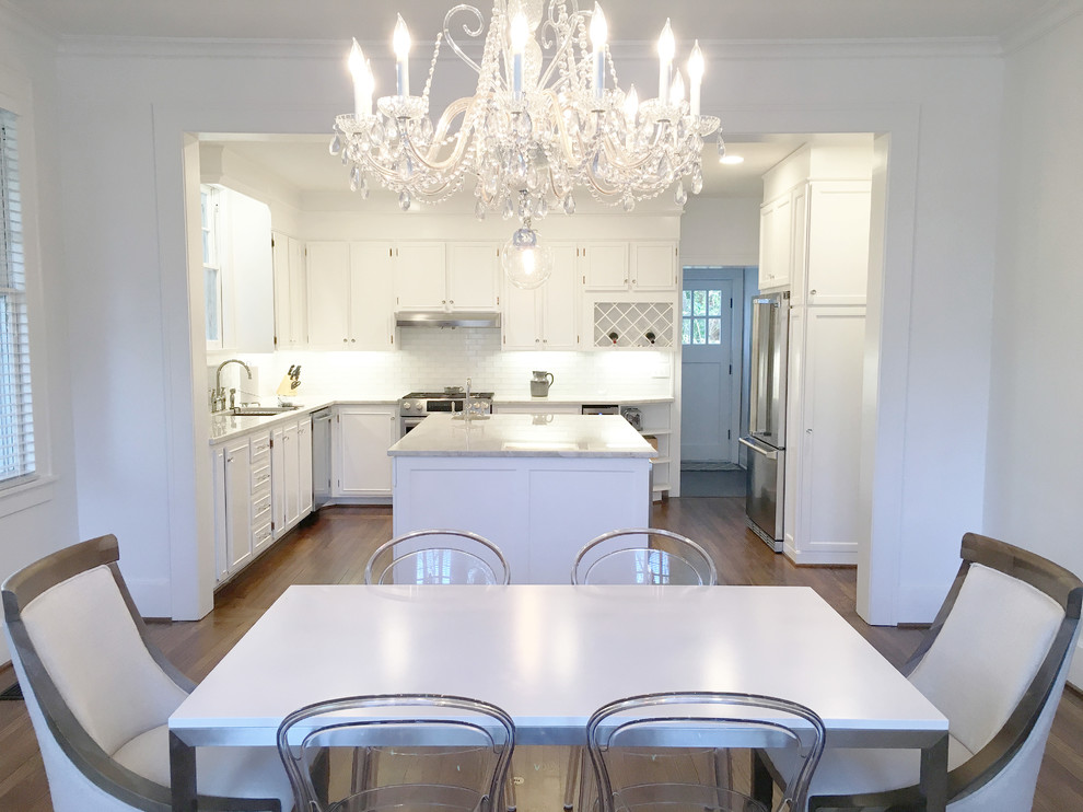 Example of a mid-sized trendy medium tone wood floor and brown floor kitchen/dining room combo design in Atlanta with white walls and no fireplace
