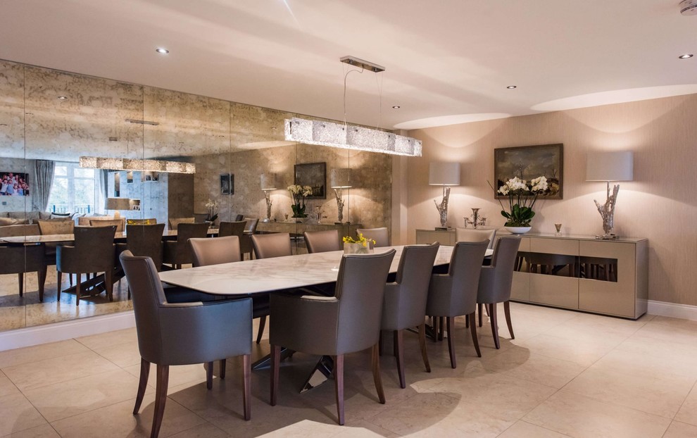 Design ideas for a contemporary dining room in Hertfordshire with beige walls, beige floors and feature lighting.