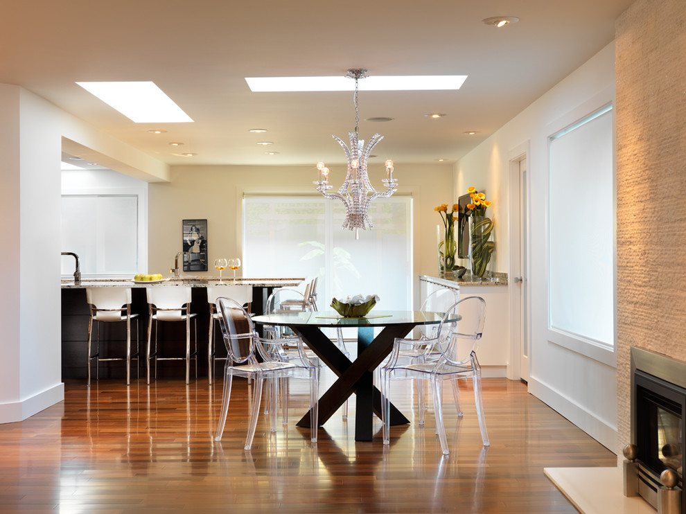 Inspiration for a contemporary kitchen/dining room in Vancouver with white walls and medium hardwood flooring.