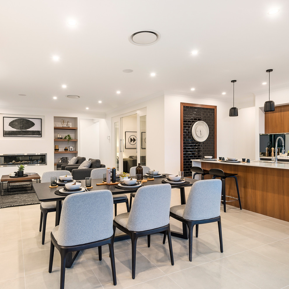 This is an example of a medium sized contemporary open plan dining room in Canberra - Queanbeyan with white walls, ceramic flooring, a ribbon fireplace, a metal fireplace surround and beige floors.