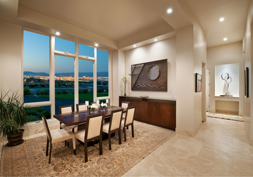 Large trendy limestone floor enclosed dining room photo in Other with white walls